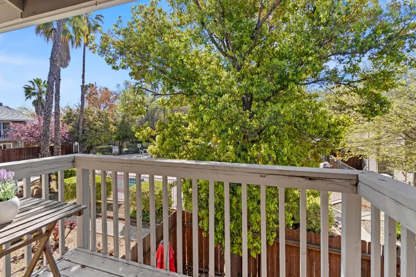 a view of a balcony with wooden floor