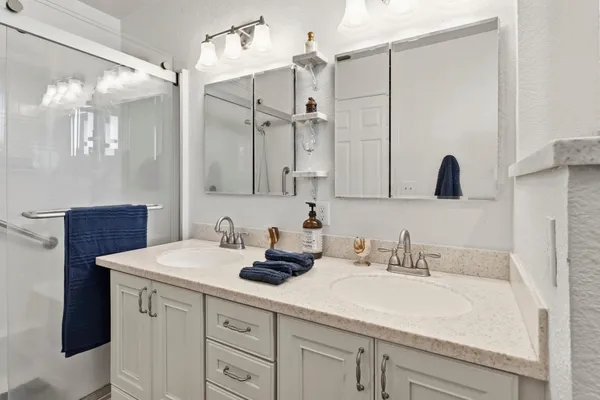 a bathroom with a sink double vanity and a mirror