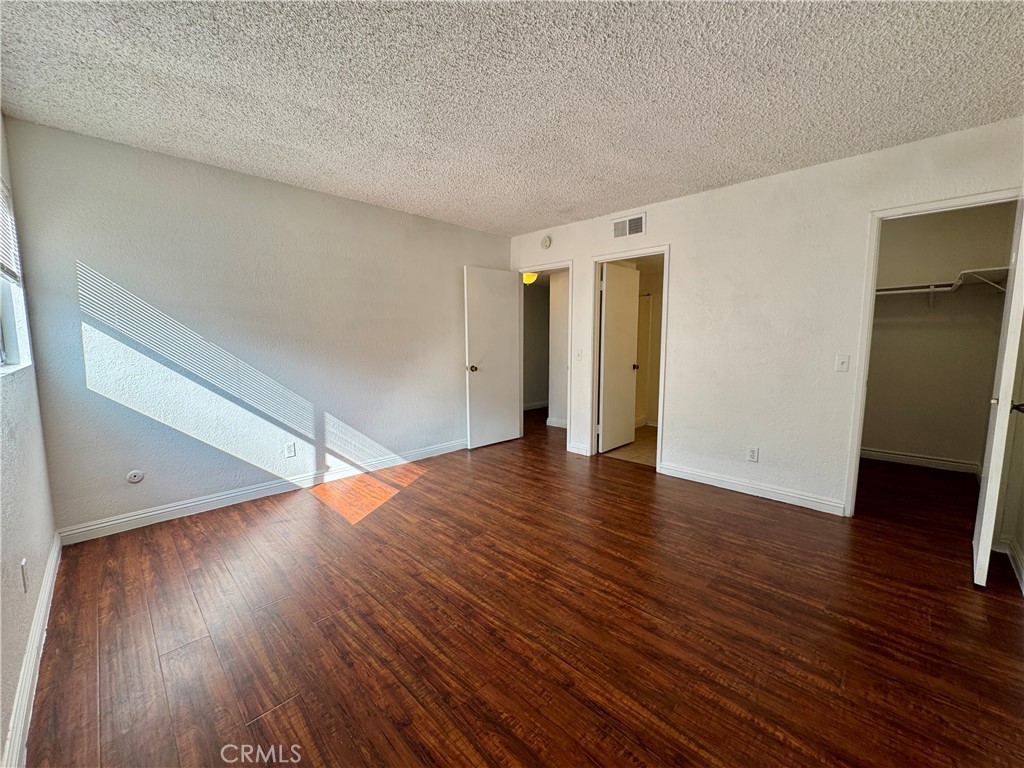241 South Curtis Avenue, Unit E Alhambra, CA 91801 - Photo 4 of 8 a view of an empty room with wooden floor and closet