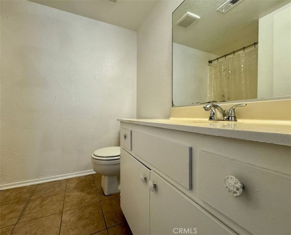 241 South Curtis Avenue, Unit E Alhambra, CA 91801 - Photo 5 of 8 a bathroom with a sink a toilet and a mirror