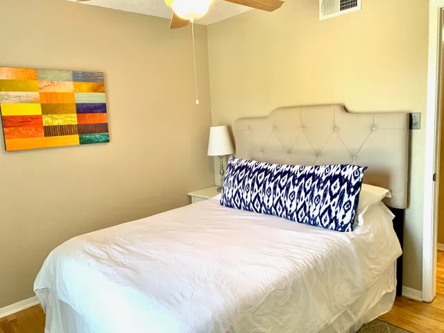 a large bed sitting in a bedroom next to a bathroom