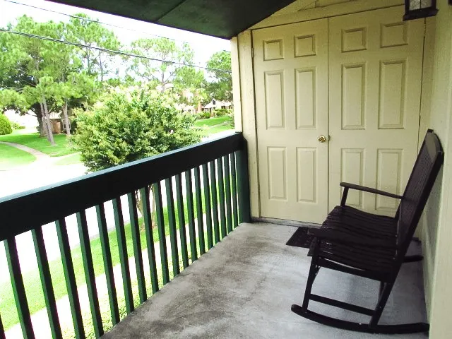 a view of balcony with wooden floor