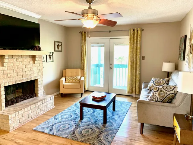 a living room with furniture a flat screen tv and a fireplace