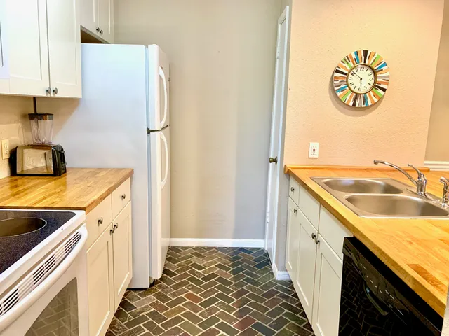 a kitchen with a sink and a refrigerator
