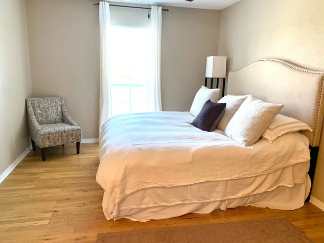 a bedroom with a bed and chair