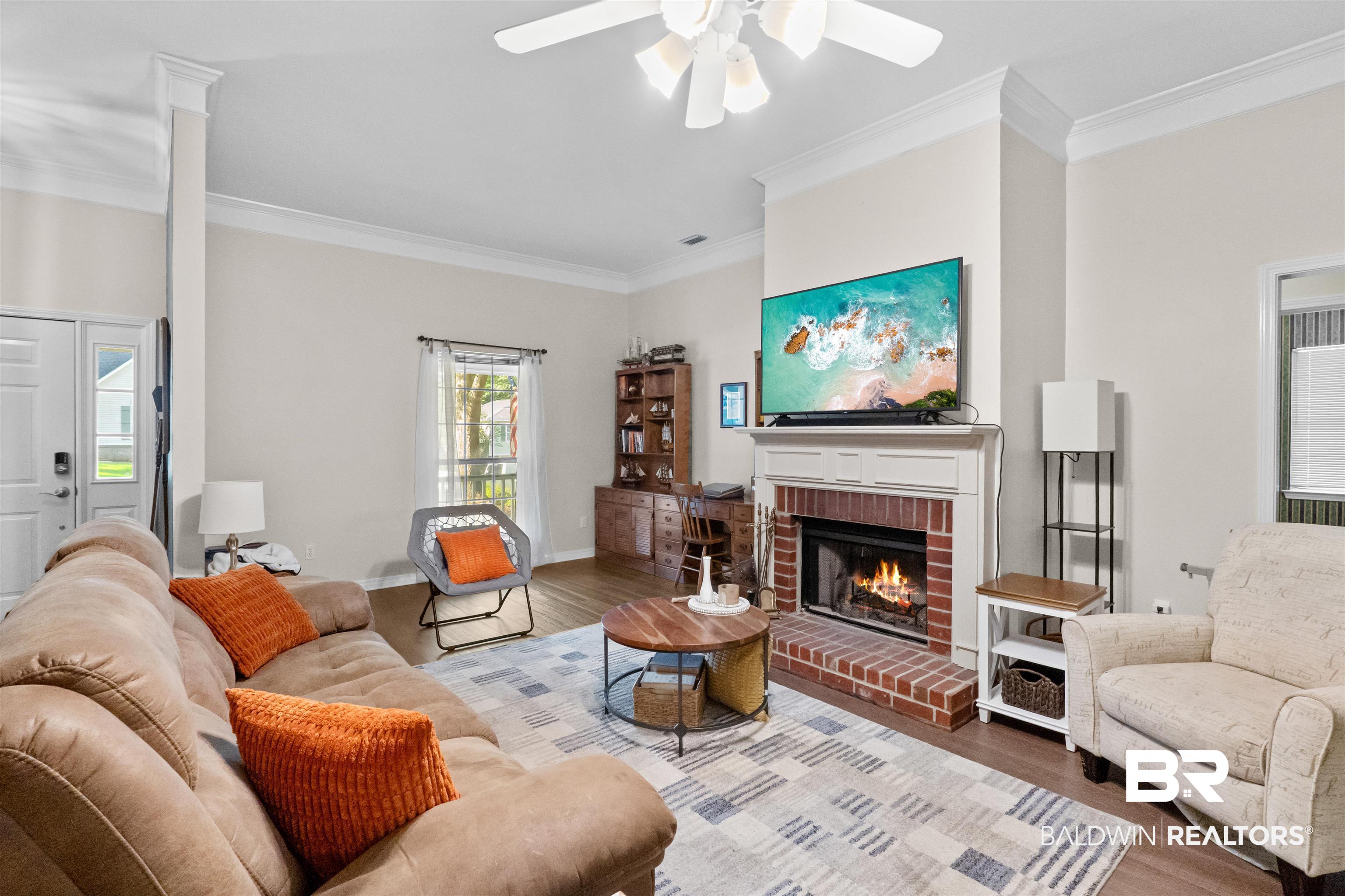 153 Lakeview Loop Daphne, AL 36526 - Photo 11 of 56 The living room offers a comfortable setting for everyday life, anchored by a cozy fireplace and enhanced by soaring ceilings overhead.