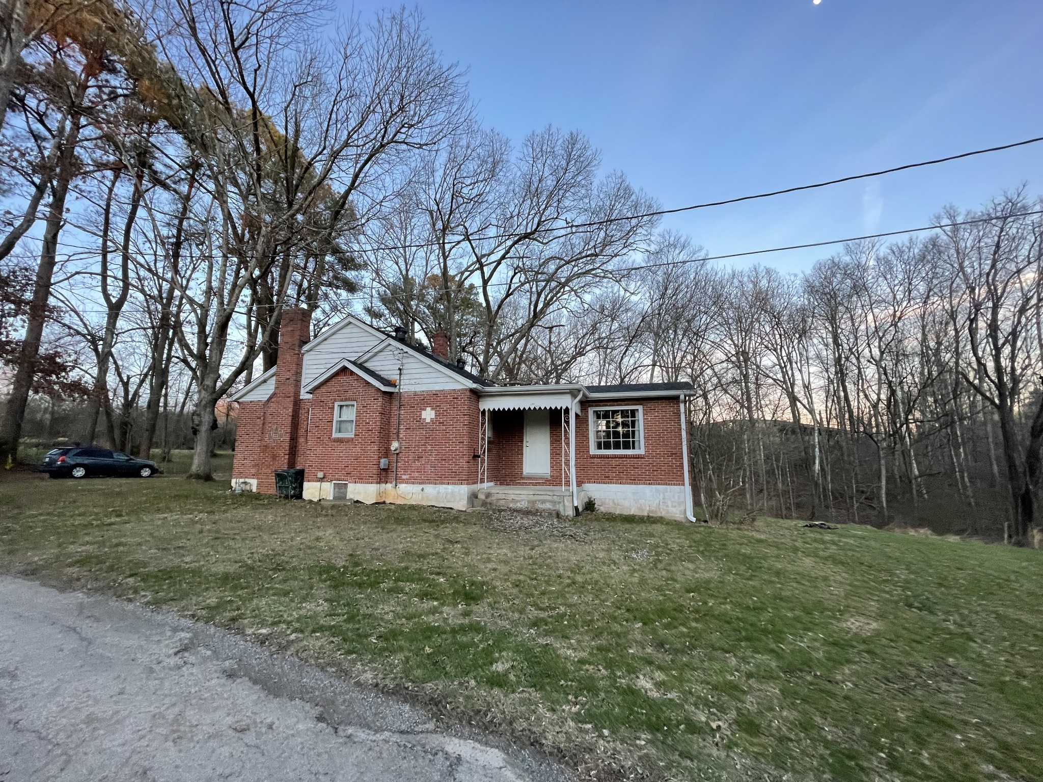401 High Point Drive Centerville, TN 37033 - Photo 5 of 23 a house that is sitting in the grass with large trees