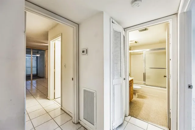 a bathroom with a glass shower door and a mirror