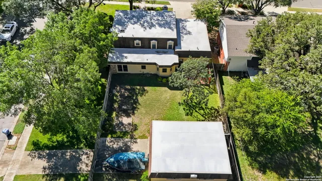 an aerial view of a house with a yard