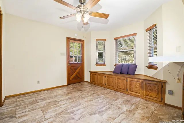 an empty room with windows and cabinet