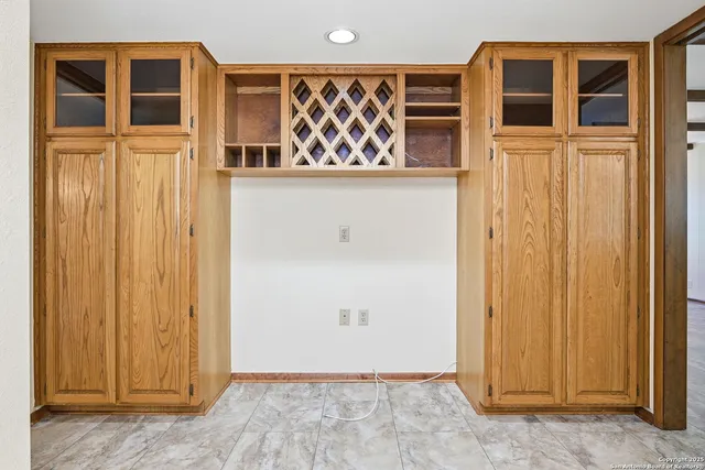 a kitchen with a stove sink and cabinets