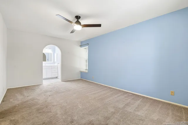 a bathroom with double vanity sink a two mirror a window and a glass door