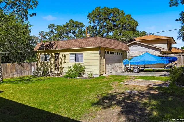 an aerial view of a house with a yard and garden