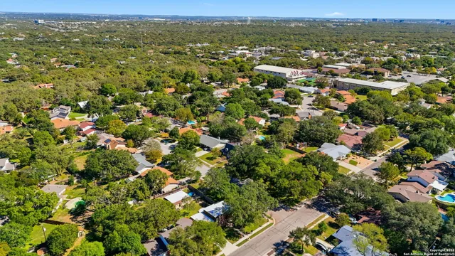 an aerial view of a house with a yard basket ball court and outdoor seating