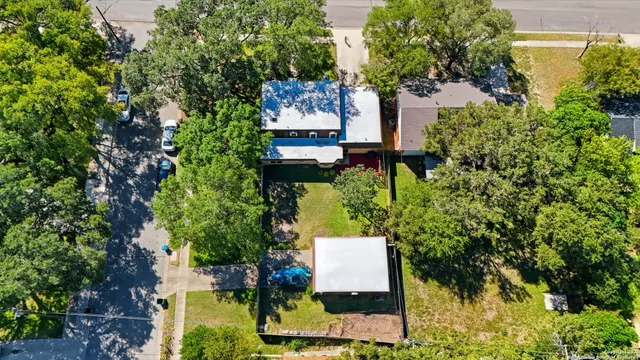 an aerial view of a house with a yard and garden