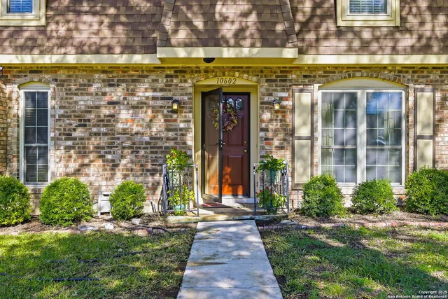 a front view of a building with a garden