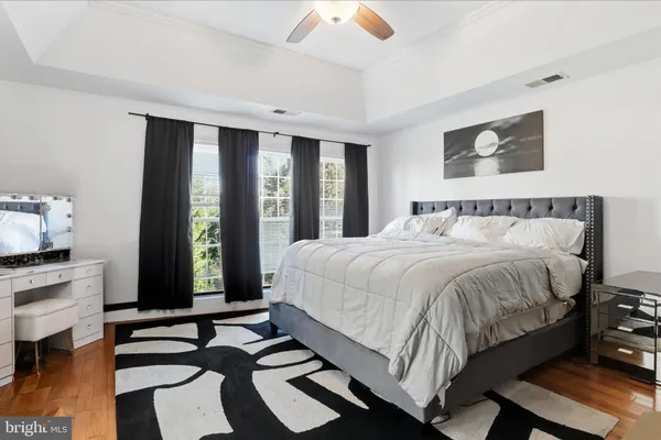 a bedroom with a bed and a large window with balcony view