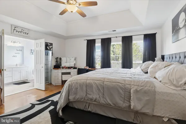 a spacious bedroom with a bed a window and walk in closet