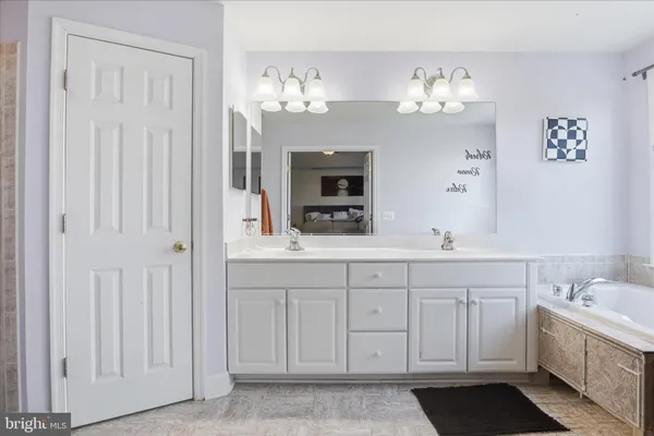 a bathroom with a sink double vanity and a mirror