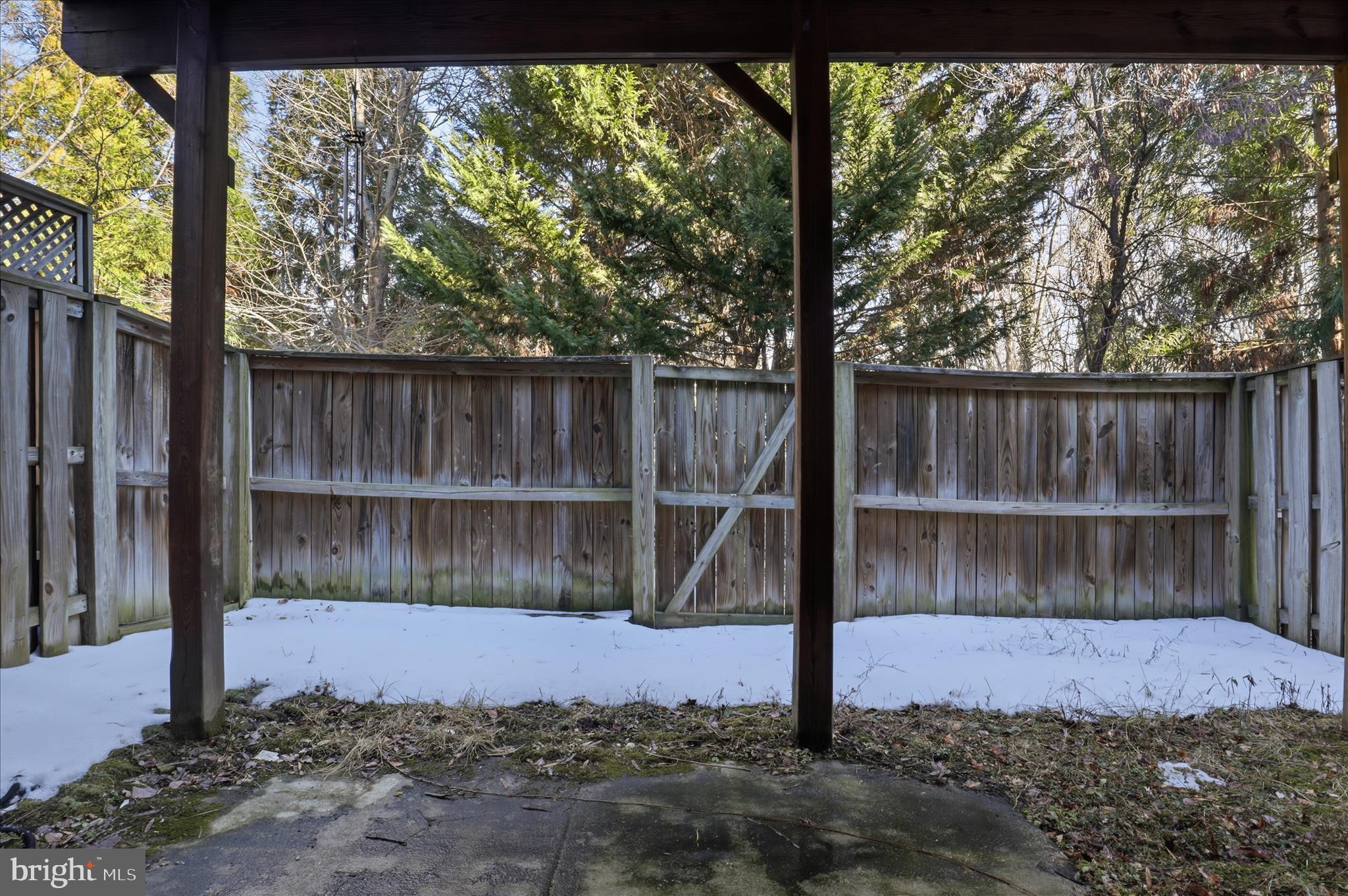 9285 Laurel Ridge Crossing Road Lorton, VA 22079 - Photo 30 of 41 a view of a backyard with a large tree and wooden fence