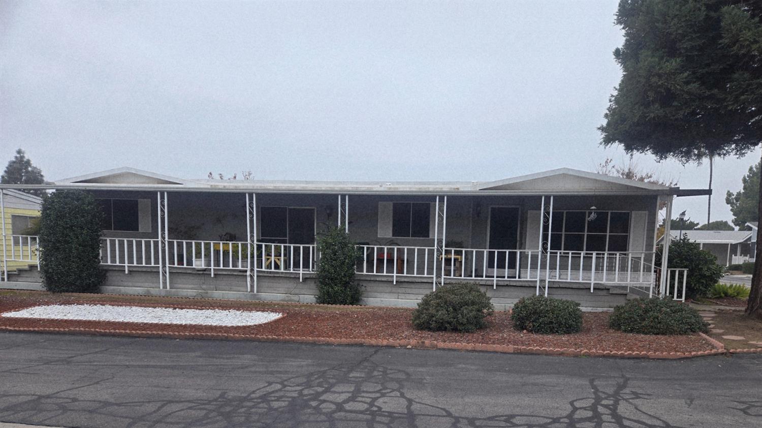 1300 West Olson Avenue, Unit 73 Reedley, CA 93654 - Photo 1 of 23 front view of a house with a yard