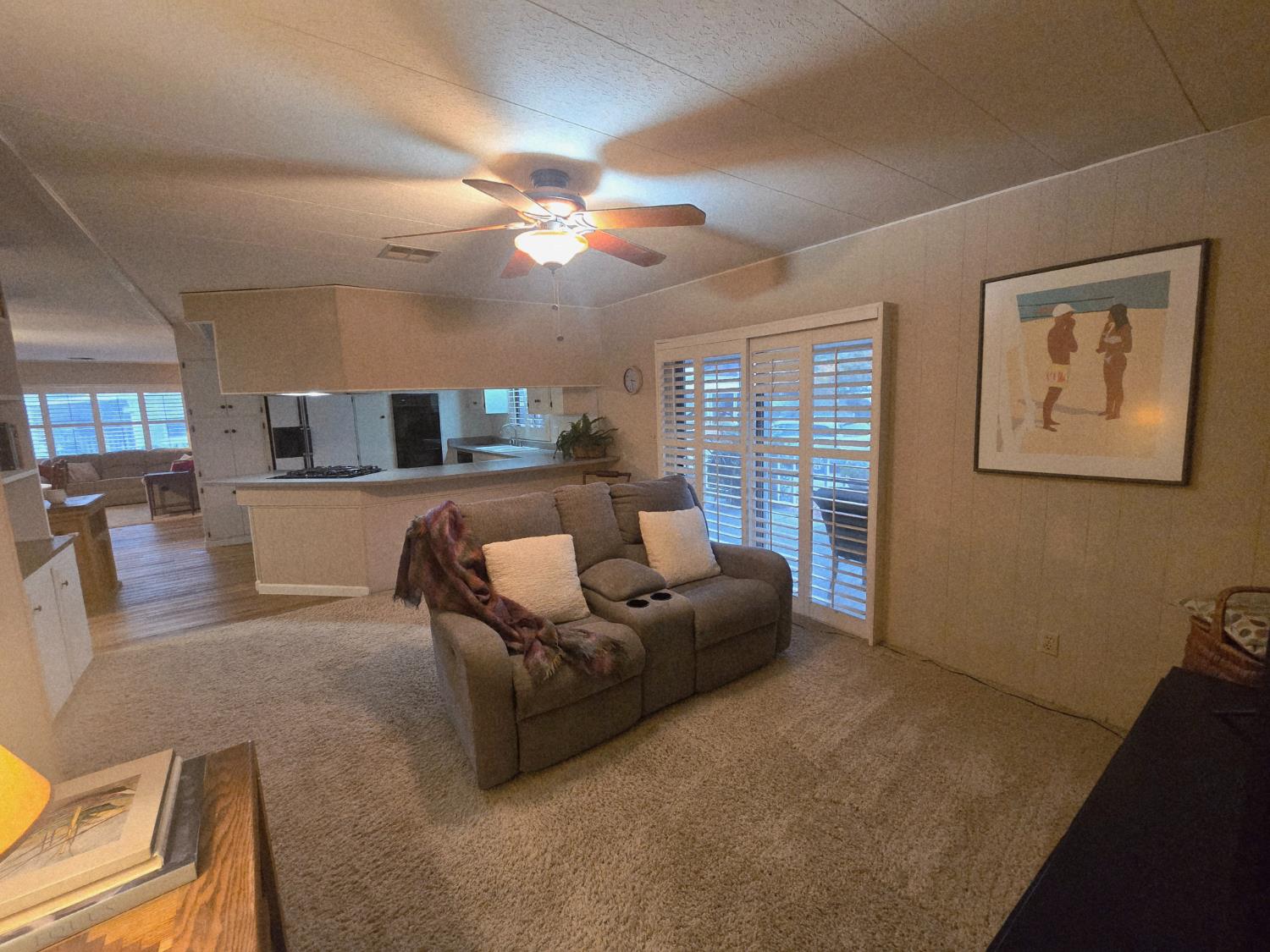 1300 West Olson Avenue, Unit 73 Reedley, CA 93654 - Photo 11 of 23 a living room with furniture and a large window