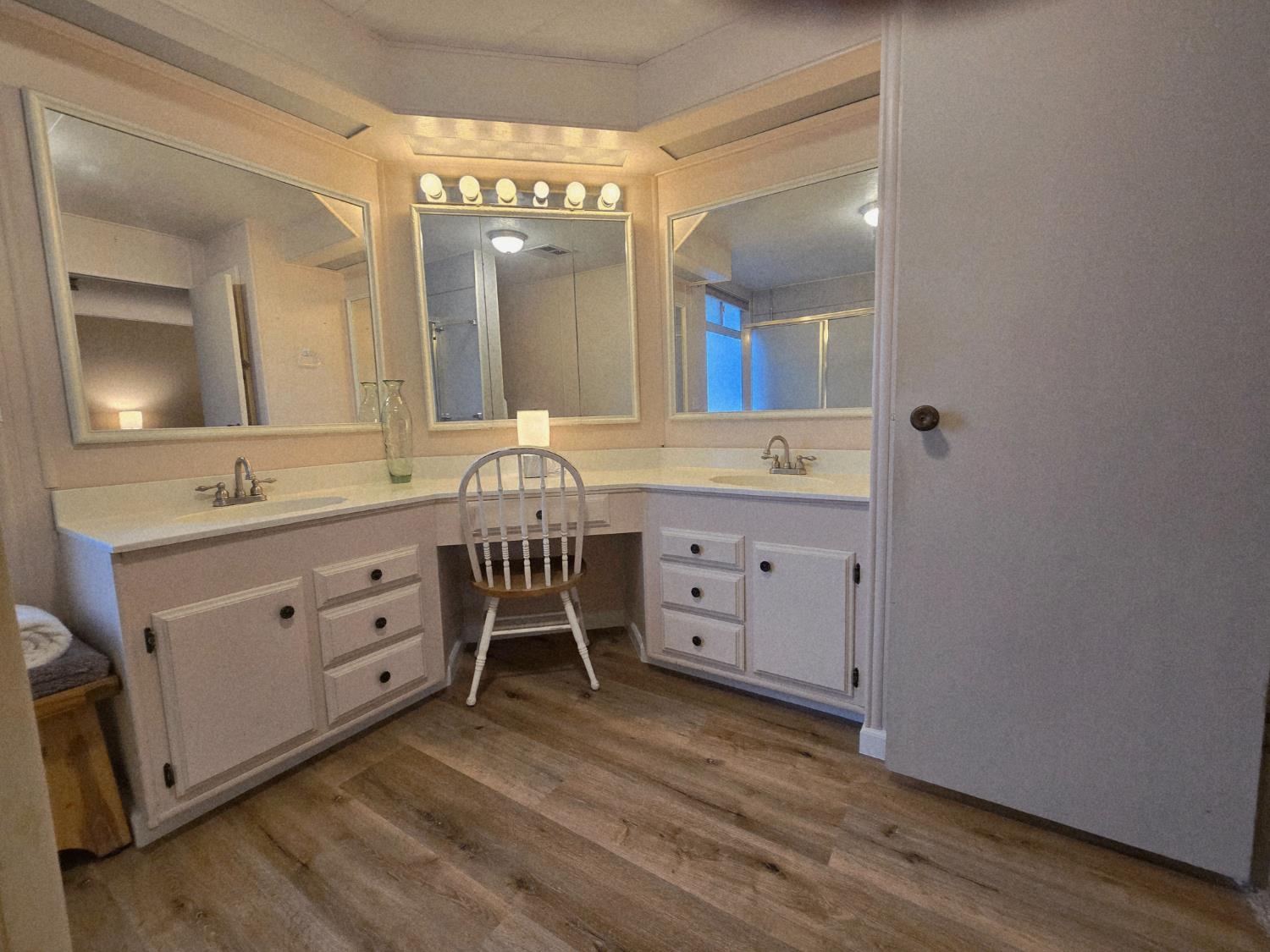 1300 West Olson Avenue, Unit 73 Reedley, CA 93654 - Photo 14 of 23 a bathroom with a double vanity sink and mirror