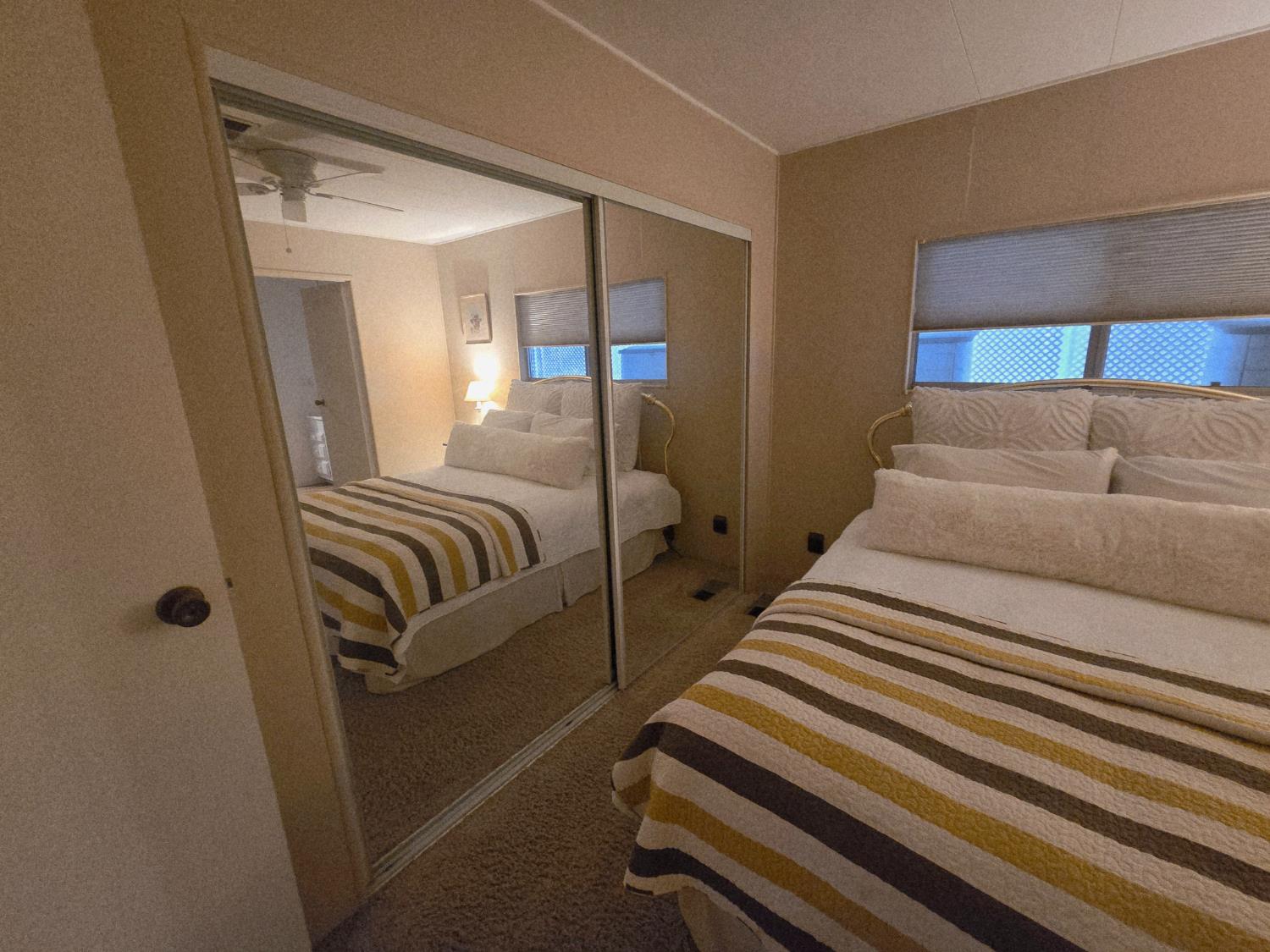 1300 West Olson Avenue, Unit 73 Reedley, CA 93654 - Photo 17 of 23 a bedroom with bed and wooden floor