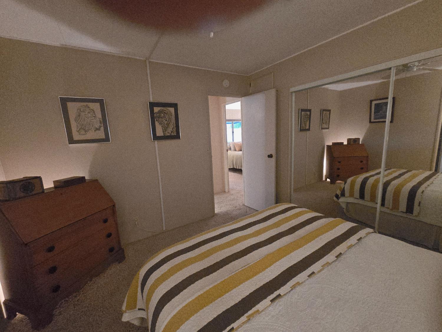 1300 West Olson Avenue, Unit 73 Reedley, CA 93654 - Photo 18 of 23 a bedroom with a bed and furniture