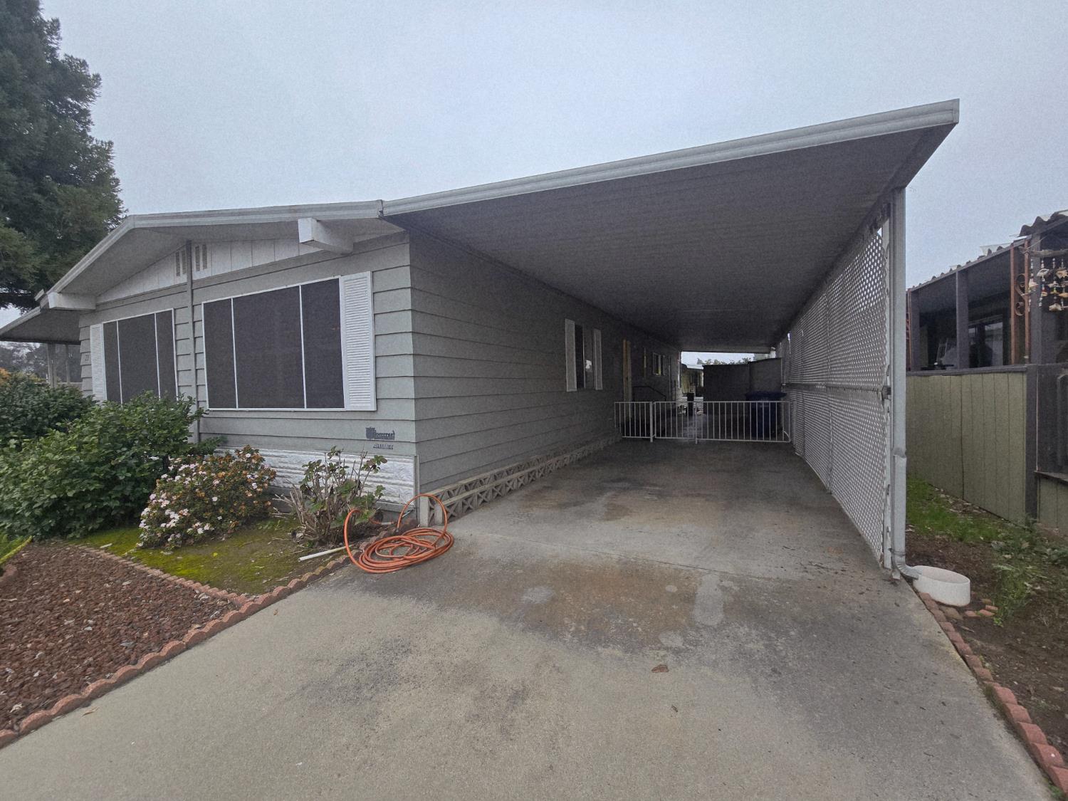 1300 West Olson Avenue, Unit 73 Reedley, CA 93654 - Photo 23 of 23 a view of a house with a yard and potted plants