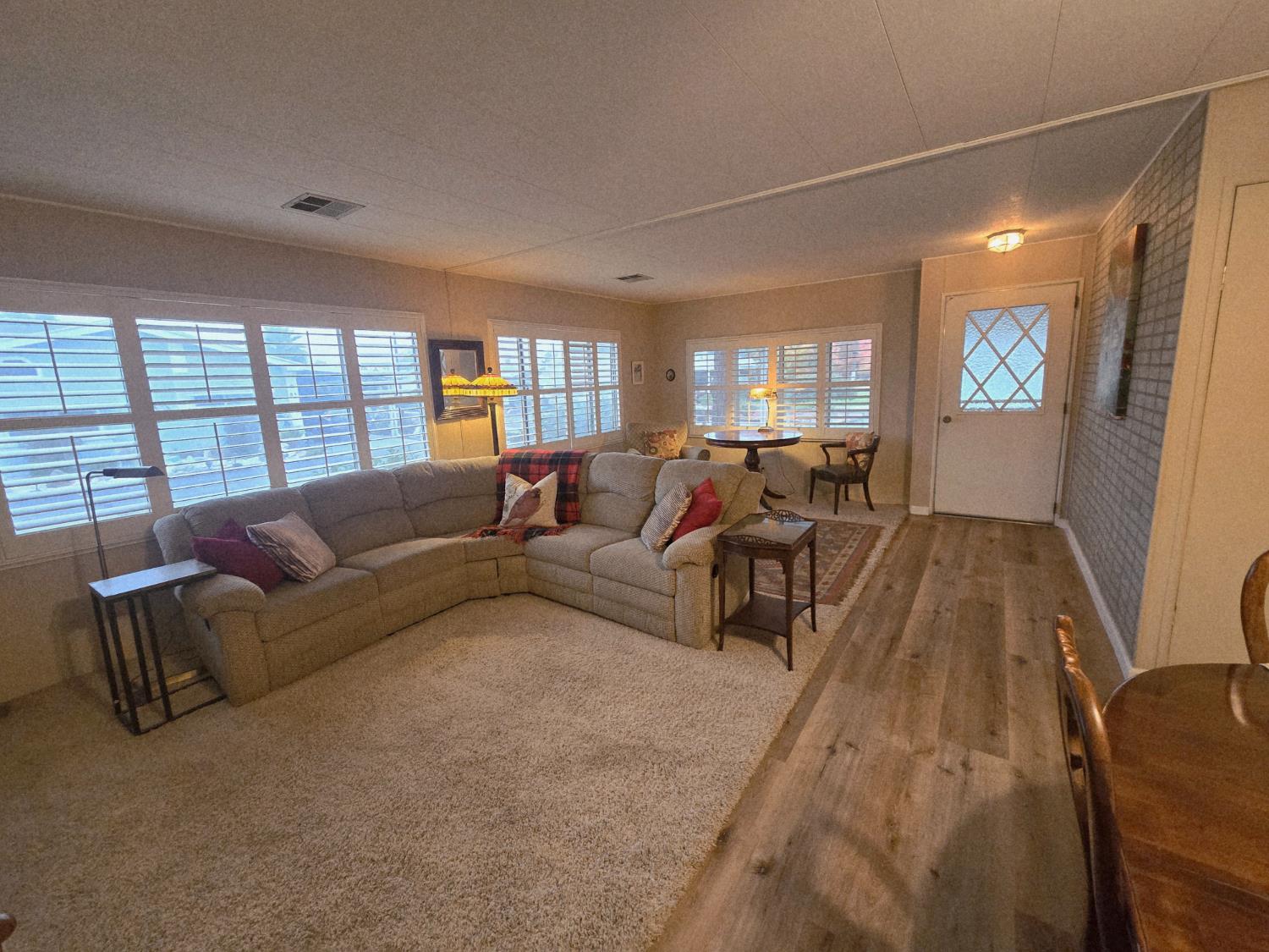 1300 West Olson Avenue, Unit 73 Reedley, CA 93654 - Photo 5 of 23 a living room with furniture and a large window