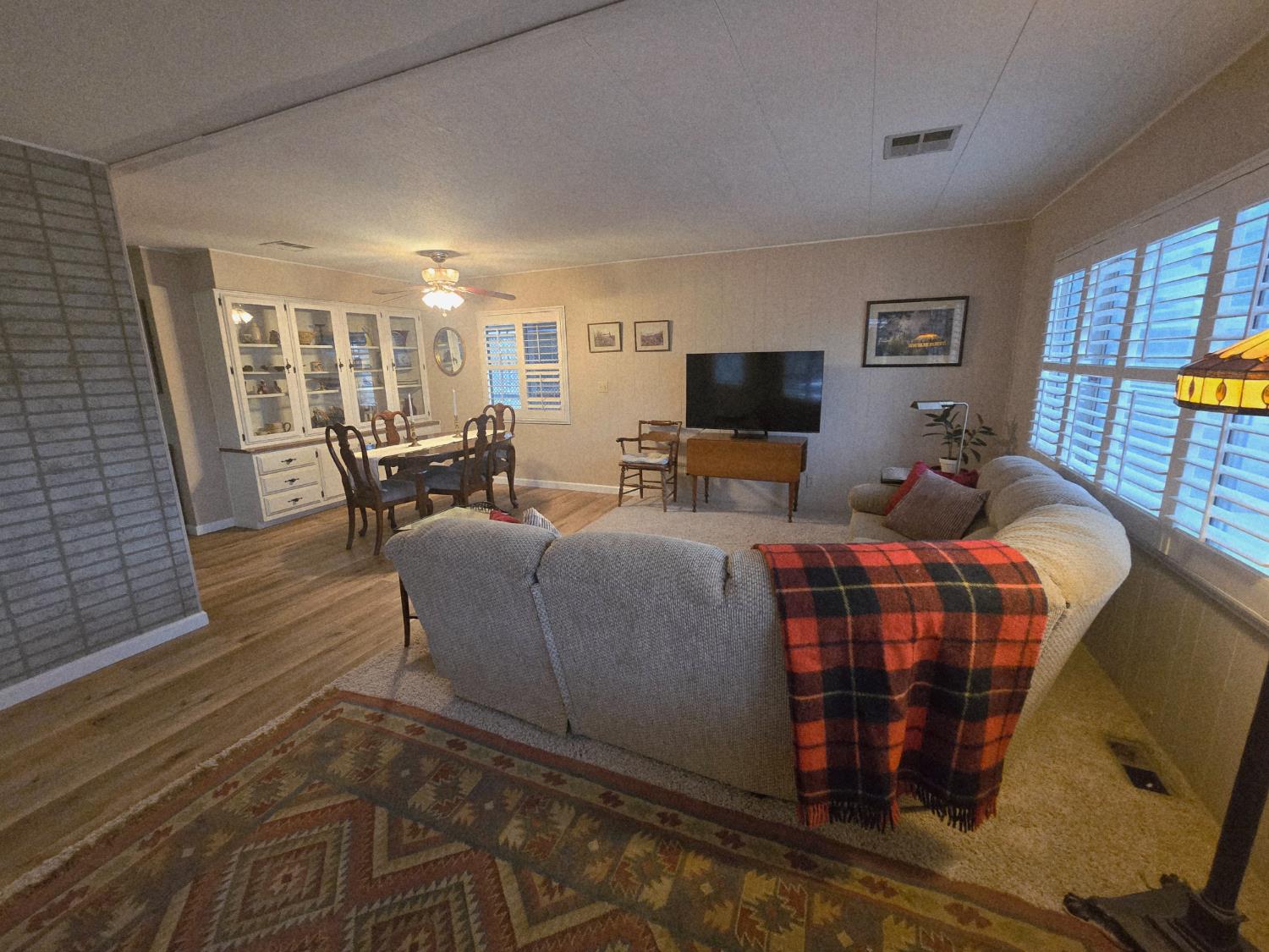 1300 West Olson Avenue, Unit 73 Reedley, CA 93654 - Photo 6 of 23 a living room with furniture and a flat screen tv