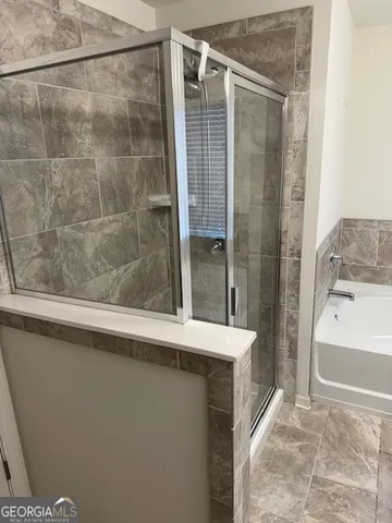 a bathroom with a shower and a sink
