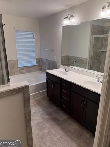 a bathroom with a sink vanity and mirror