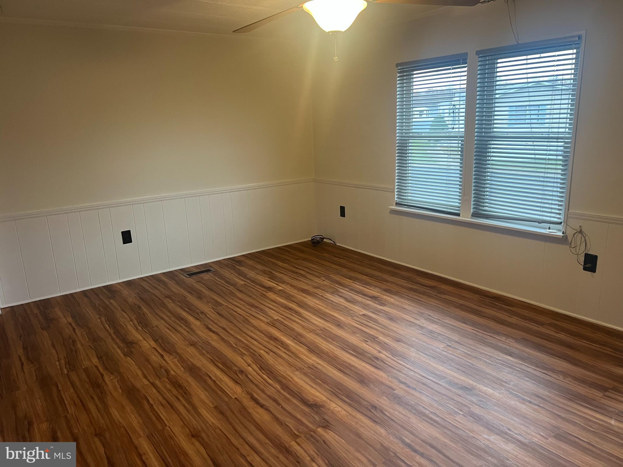 577 Miles Standish Lane Buena, NJ 08310 - Photo 3 of 7 wooden floor in an empty room with a window