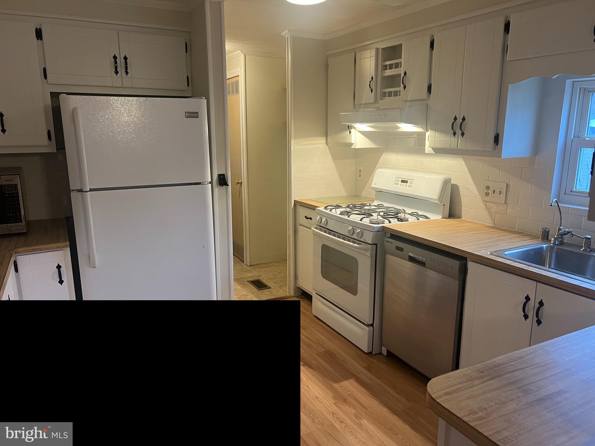 577 Miles Standish Lane Buena, NJ 08310 - Photo 6 of 7 a kitchen with a refrigerator stove and white cabinets