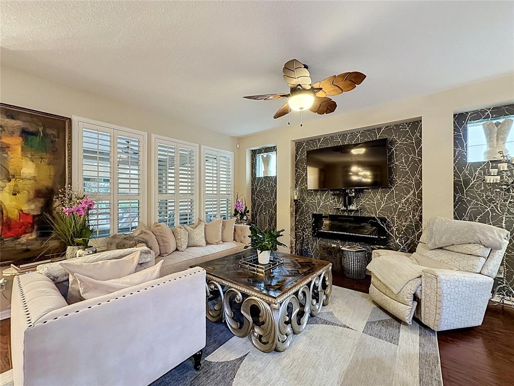 255 Silver Maple Road Groveland, FL 34736 - Photo 12 of 68 a living room with furniture and a flat screen tv