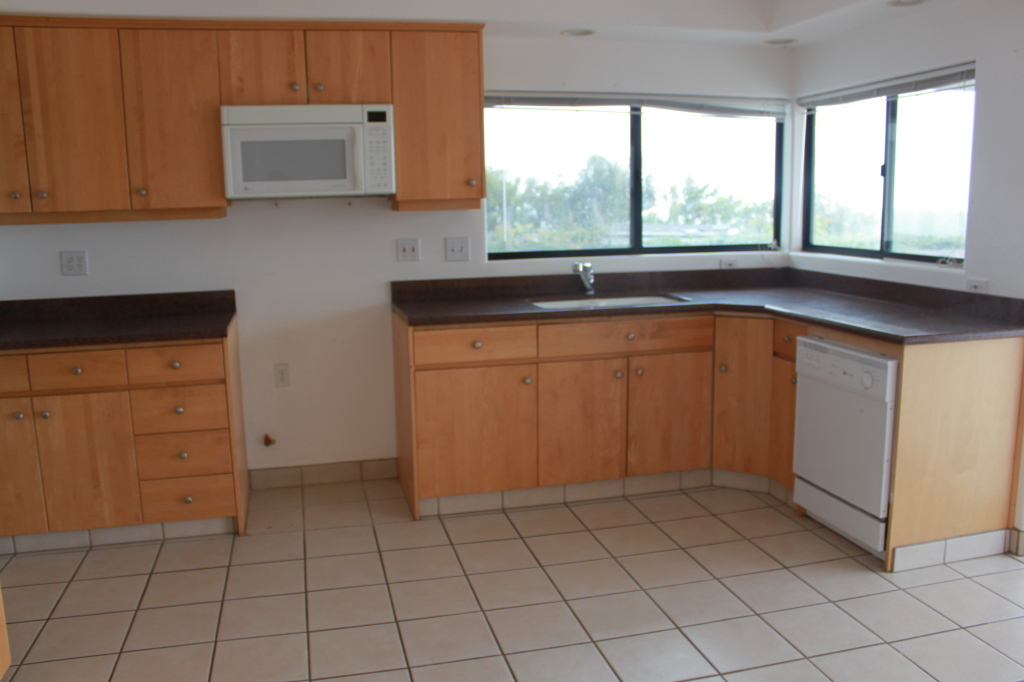 1186 Palomino Road Santa Barbara, CA 93105 - Photo 11 of 21 a kitchen with white cabinets a sink and a window