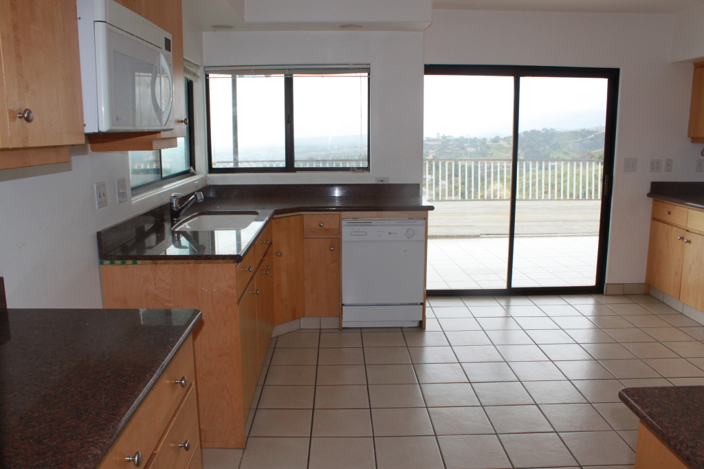 1186 Palomino Road Santa Barbara, CA 93105 - Photo 2 of 21 a kitchen with a sink a stove and cabinets