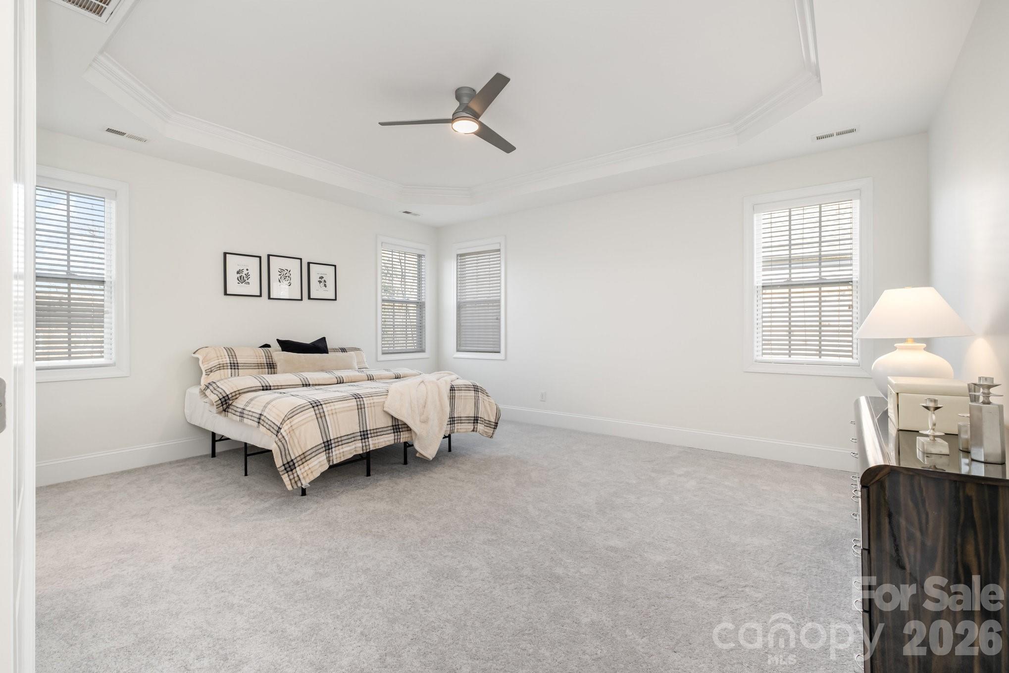 5019 Mesa Verde Road Charlotte, NC 28277 - Photo 21 of 40 a bedroom with a bed and a chandelier