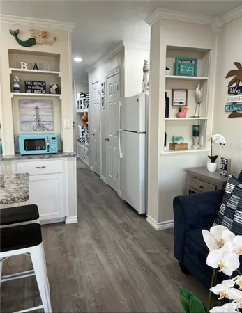 a bedroom with a bed and painting on the wall