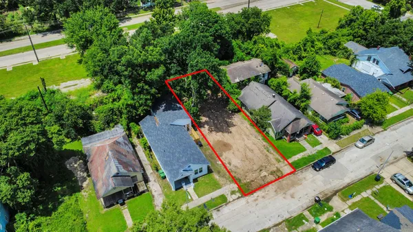 an aerial view of a house a yard and outdoor seating