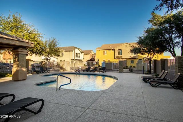 a view of swimming pool with outdoor seating and a trees