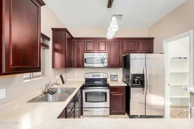 a kitchen with a refrigerator stove and sink