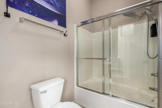 a bathroom with a shower and toilet