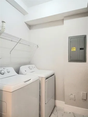 a bathroom with a granite countertop toilet a sink and a mirror