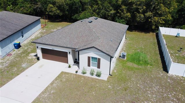 a aerial view of a house with a yard and garage