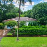 a view of a garden with a bench in a garden
