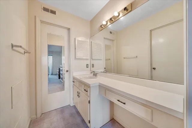 a bathroom with a sink a mirror and a shower