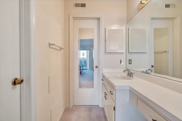 a bathroom with a double vanity sink a mirror and a shower